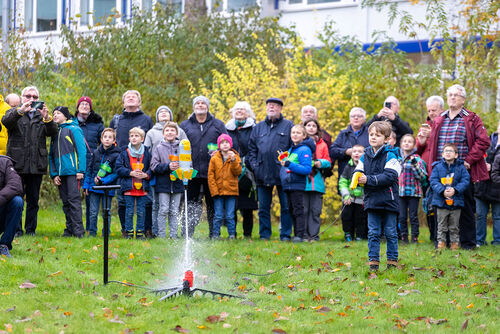 Kinder und Senioren lassen selbsgebastelte Raketen abheben